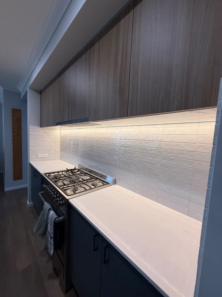 Warm-white LED strip lighting installed beneath kitchen overhead cupboards